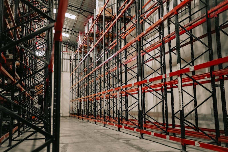 Empty warehouse with rows of pallet racking ready for liquidation