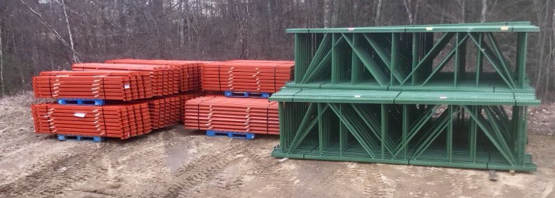 Used pallet racking — green uprights and orange beams staged and ready to ship