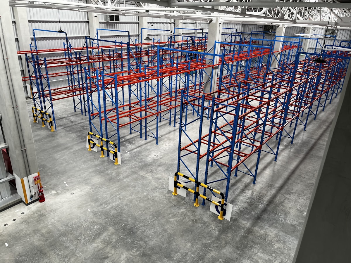 Selective pallet racking with uprights and beams standing in a warehouse — used racking in good condition